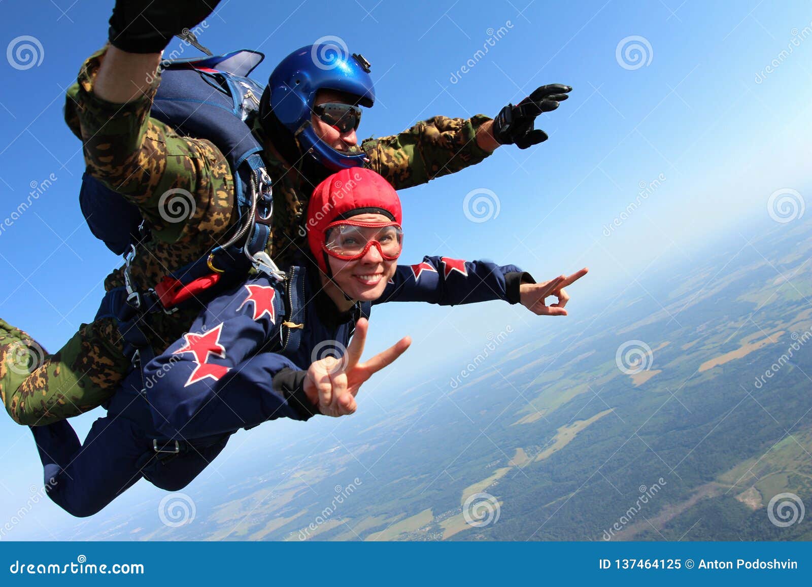 skydiving tandem is falling in the blue sky.