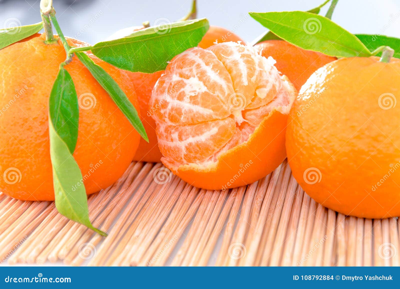 tangerine or clementine with green leaf 