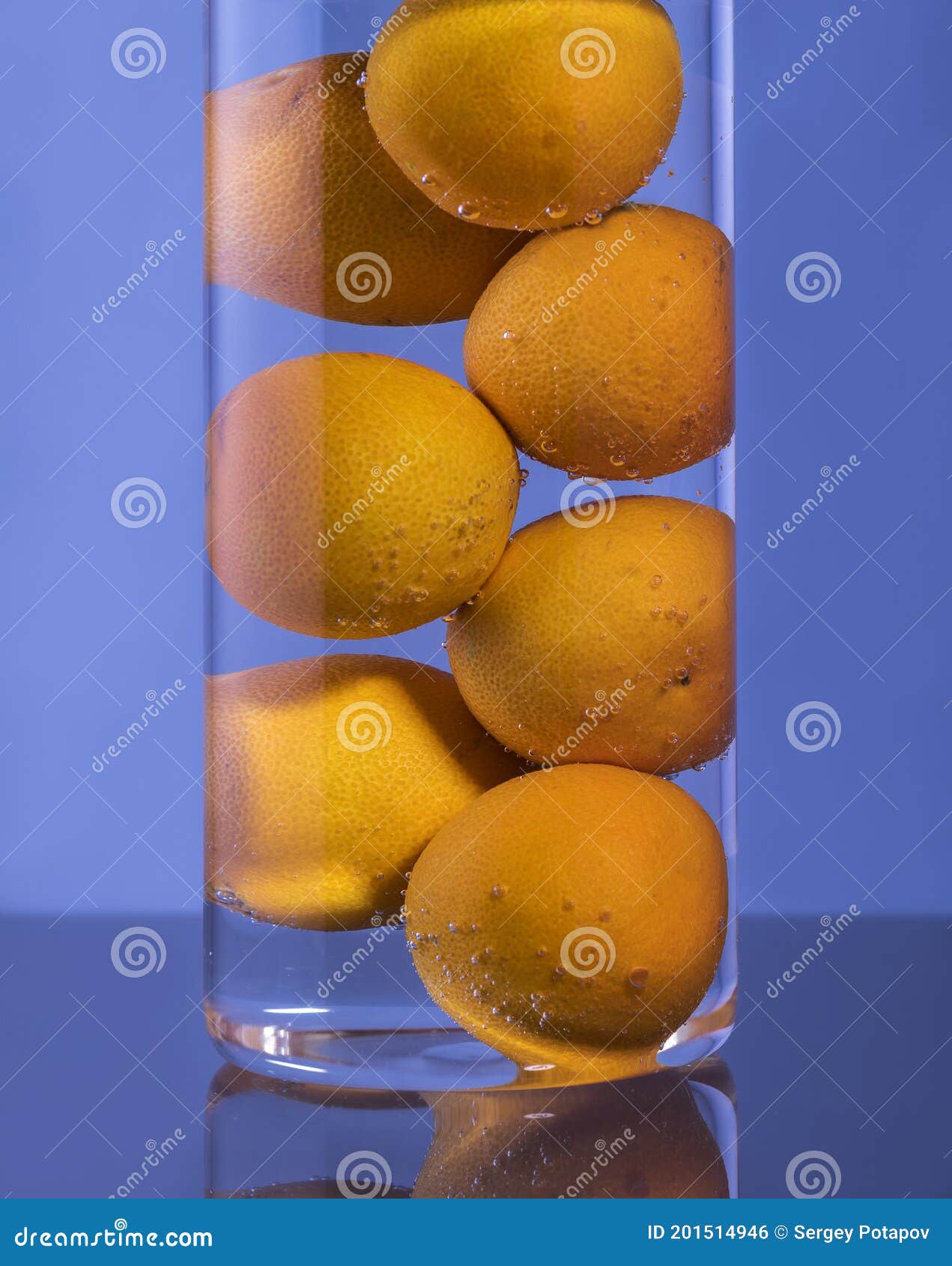 Tangerines in a Glass Glass with Water and Gas Bubbles Stock Photo