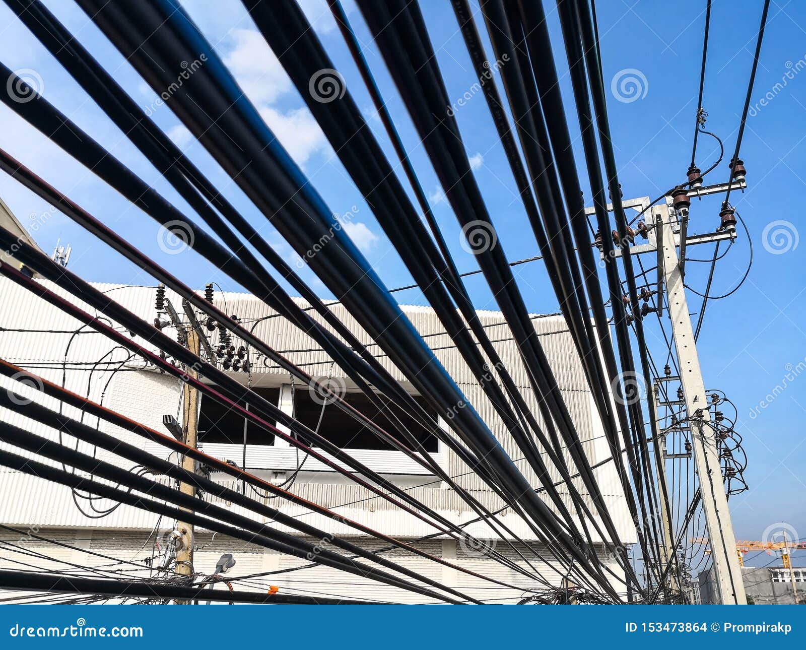Tangle Of Electrical Cables And Communication Wires On Electric Pole
