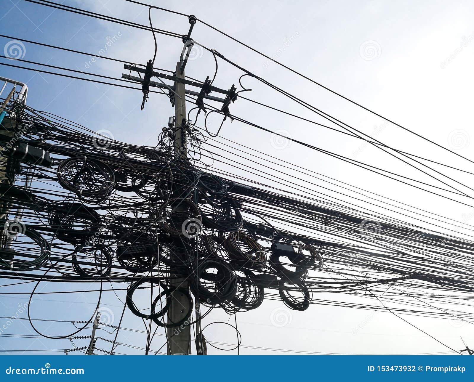 Tangle of Electrical Cables and Communication Wires on Electric Pole