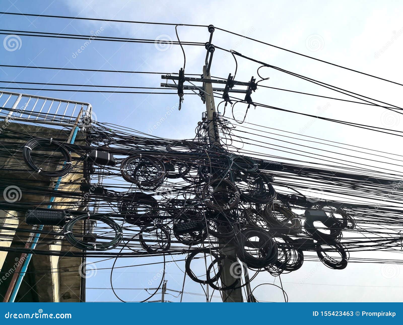 Tangle Of Electrical Cables And Communication Wires On Electric Pole