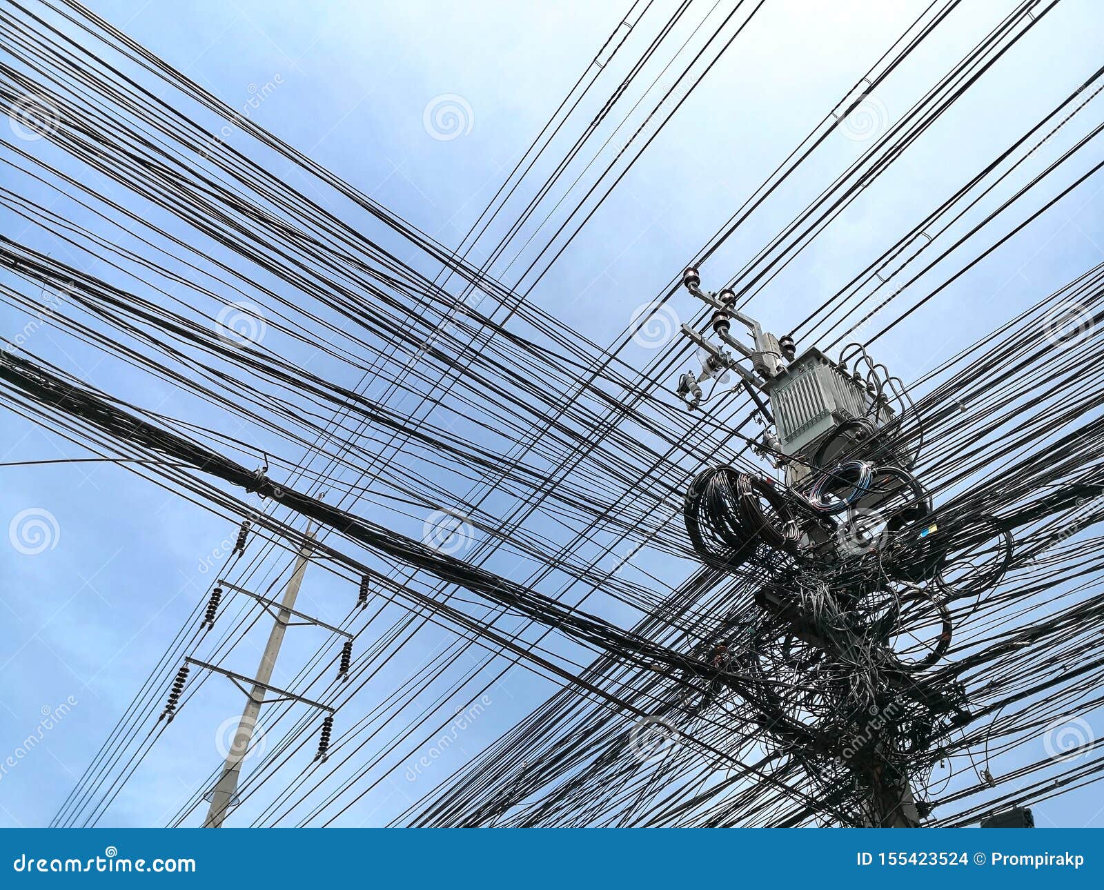 Tangle of Electrical Cables and Communication Wires on Electric Pole