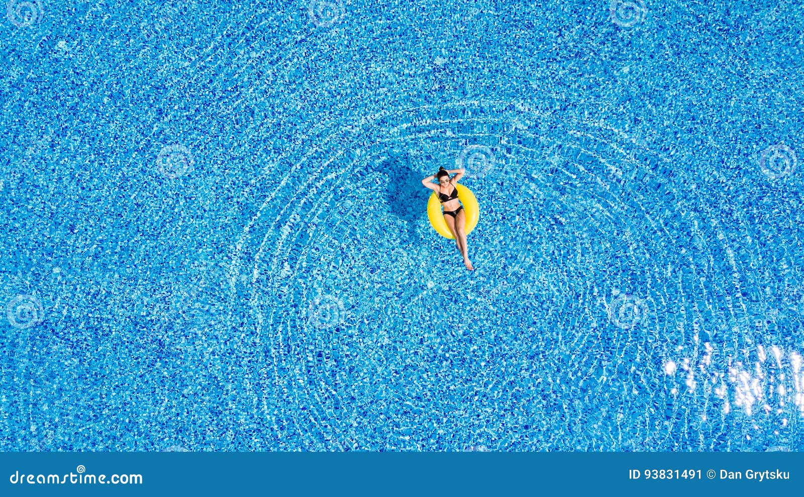 Tanning in a Pool. Woman Relax in the Pool in Sunny Day in Yellow ...