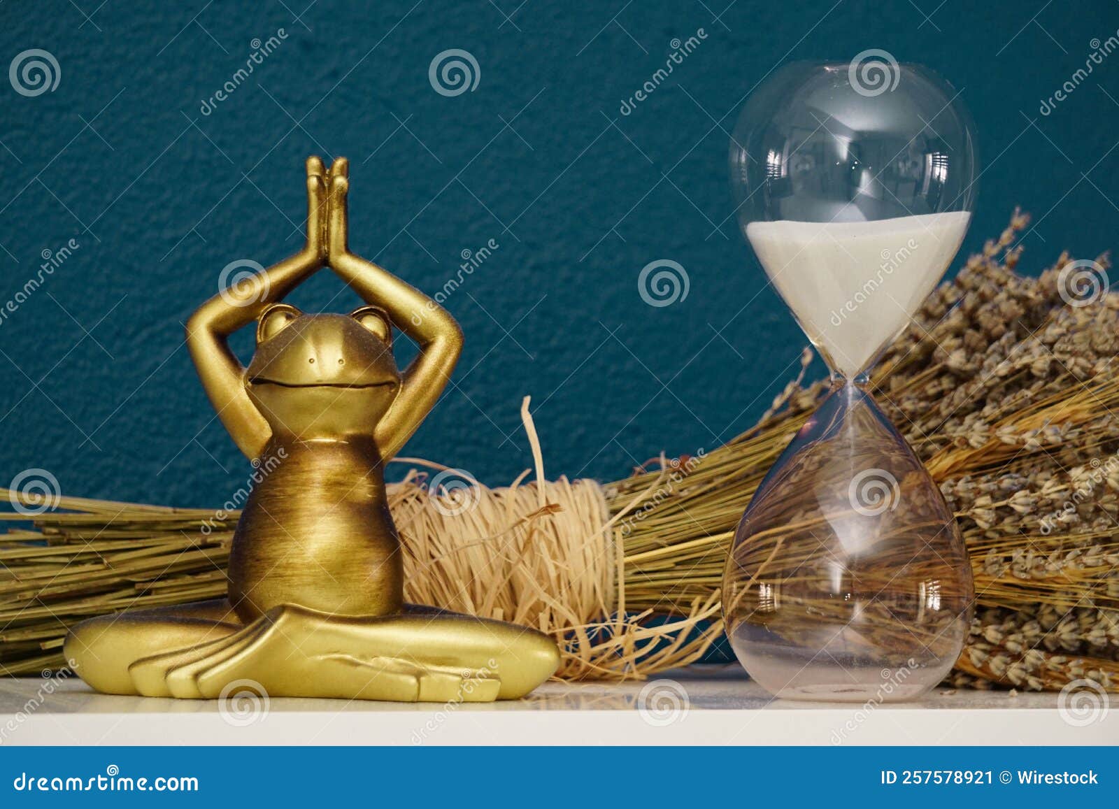 tantra position frog figurine and sand clock