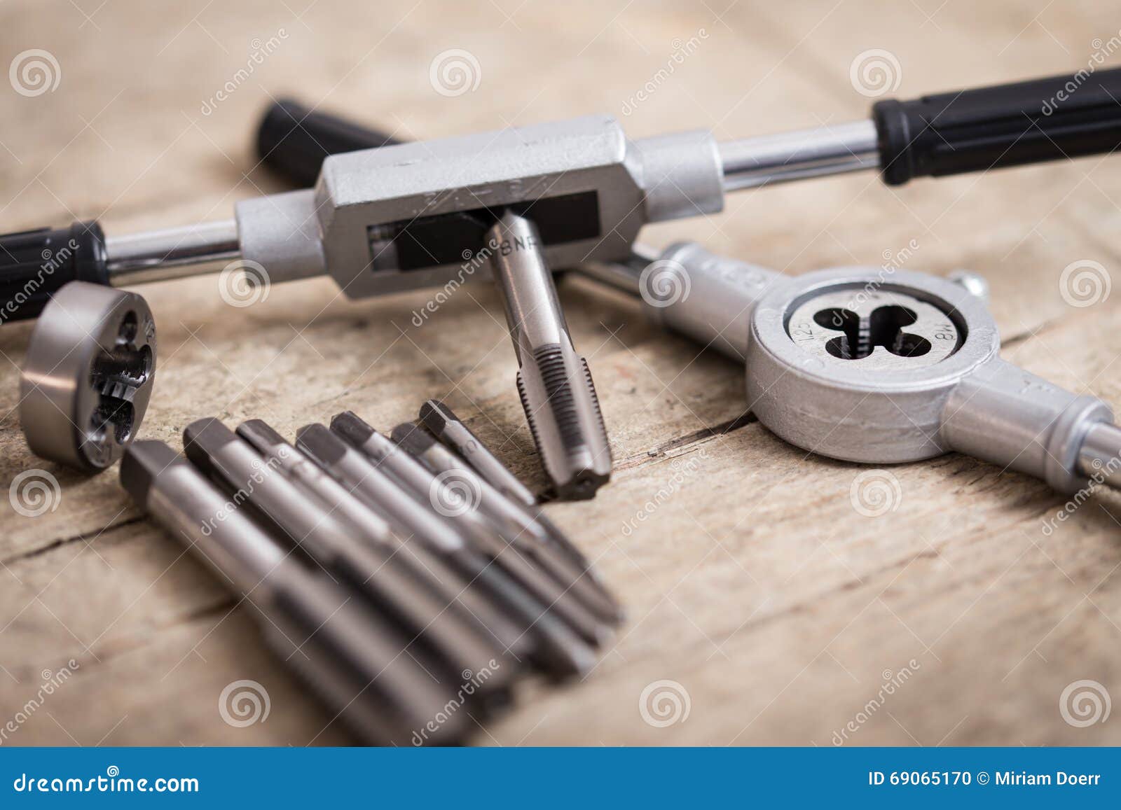 Tap die on a wooden table stock photo. Image of metal 69065170