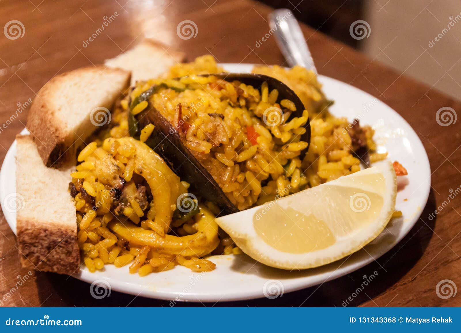 Paella Small, Typical Spanish Rice With Seafood In Individual Po