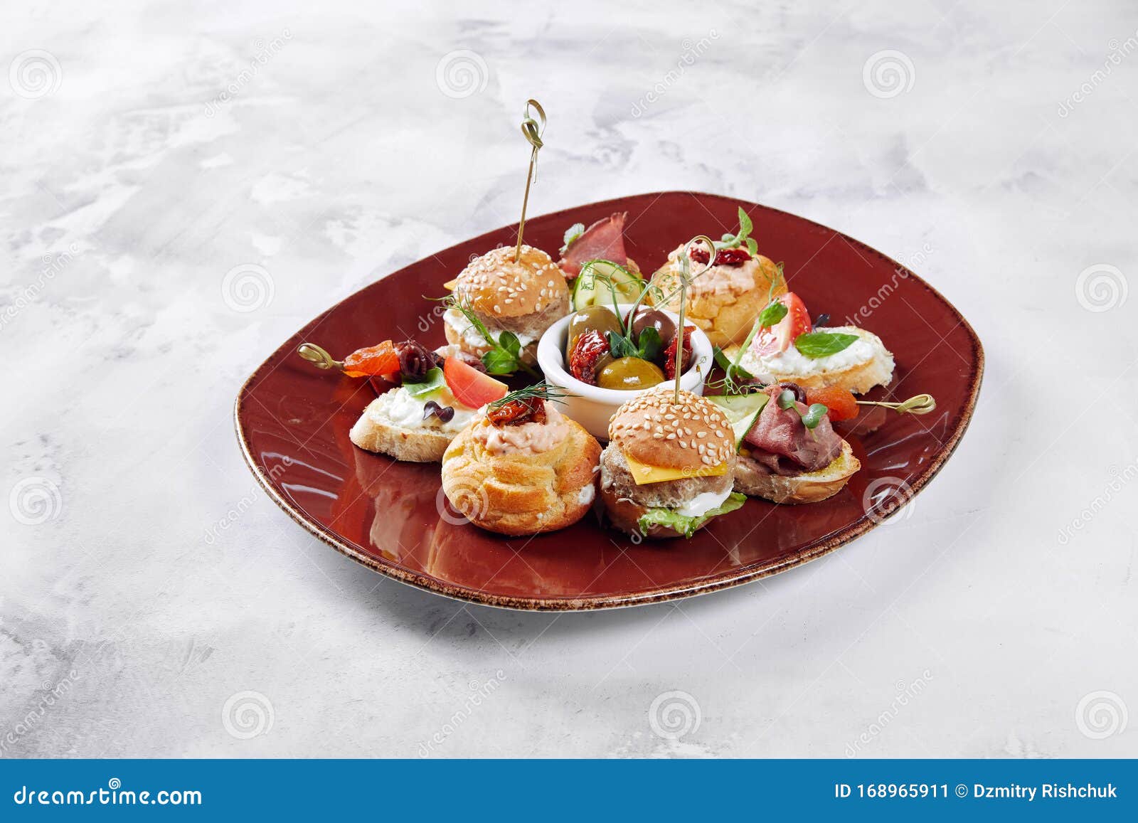 Tapas in the Form of Hamburgers with Meat Cucumbers, with Vegetables and Cheese, on a Red Plate Stock Image - Image background,