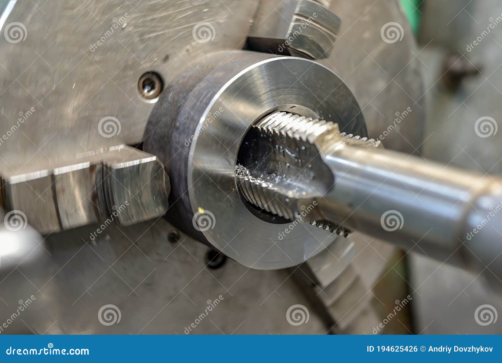 Tapping on a Lathe, the Tap Cuts the Hole by Applying Pressure from the Tailstock Stock Photo