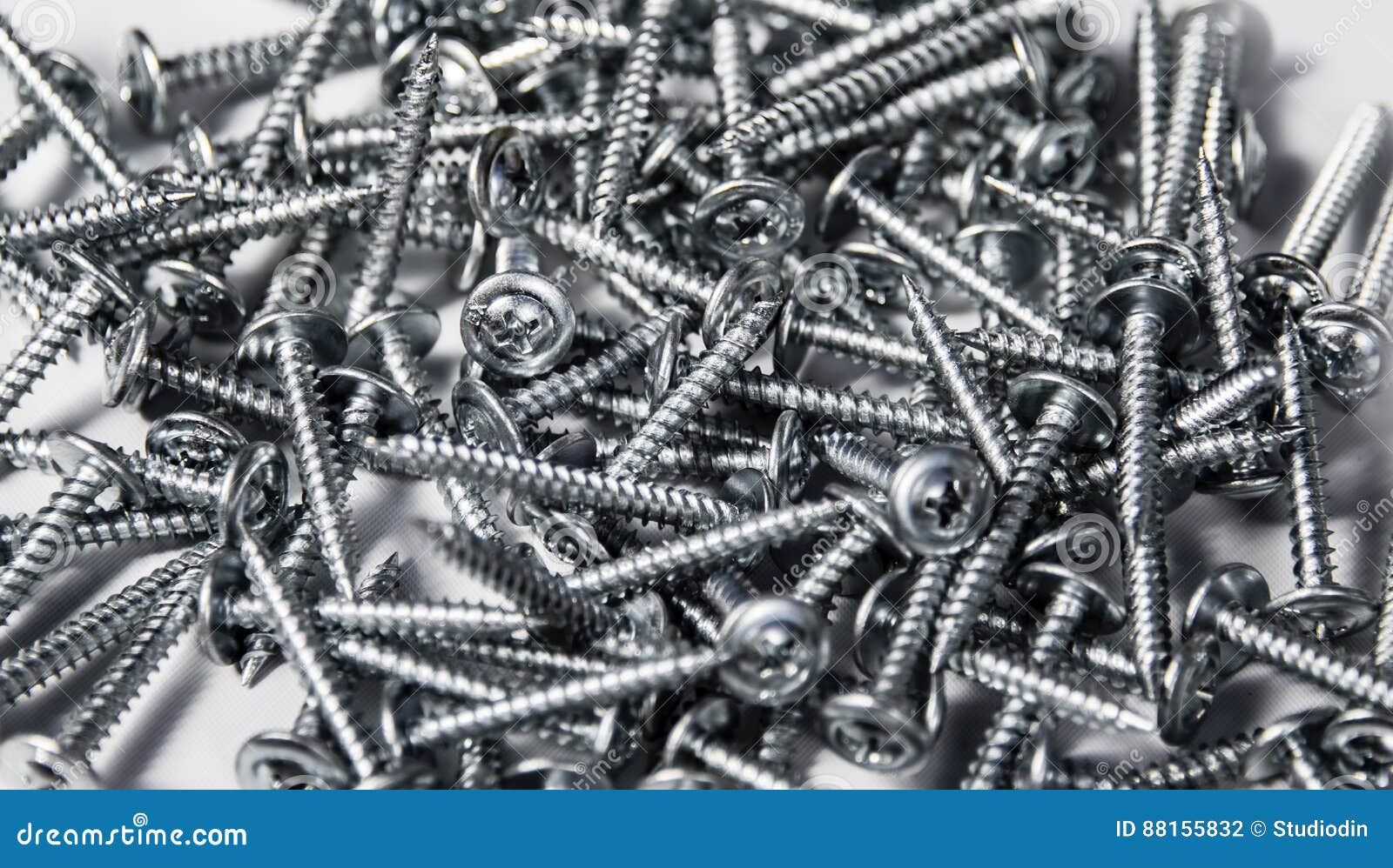 tapping screws made od steel, metal screw, iron screw, chrome screw, as a background, wood