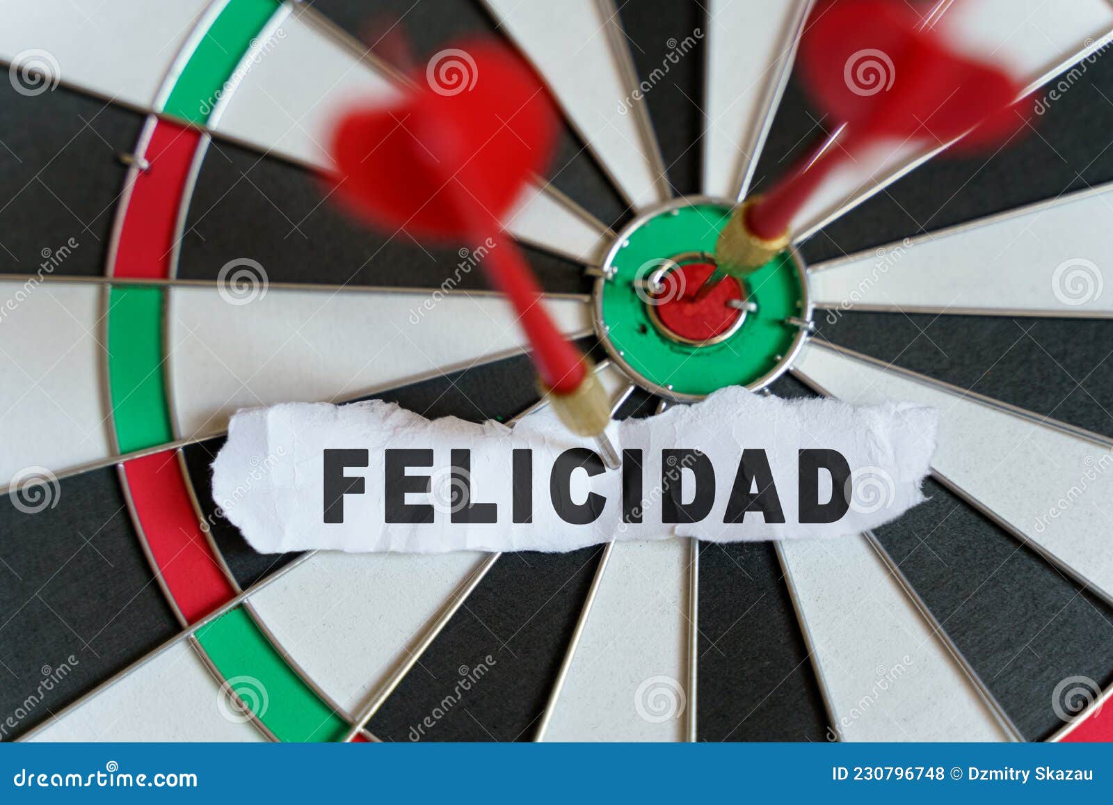 the picture shows a target, darts and a torn piece of paper with the inscription - felicidad