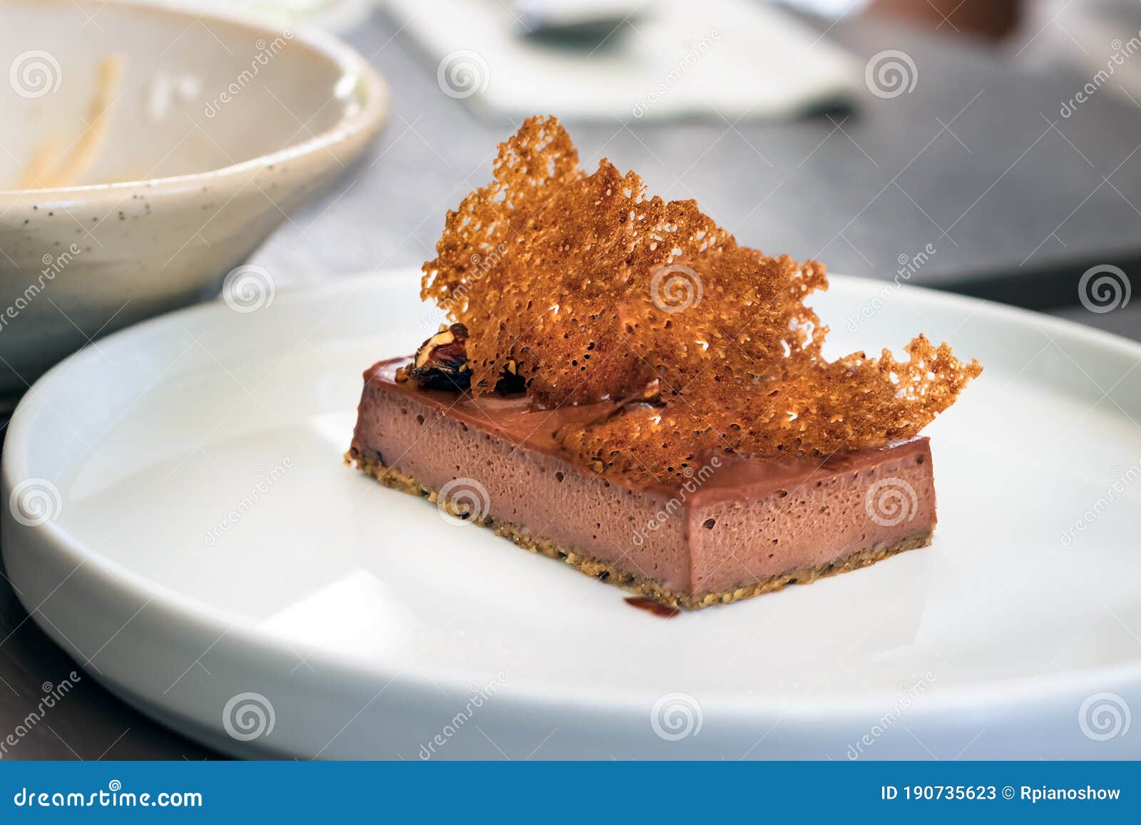 Tart with Three Chocolates. Gourmet Dessert on a White Plate Stock