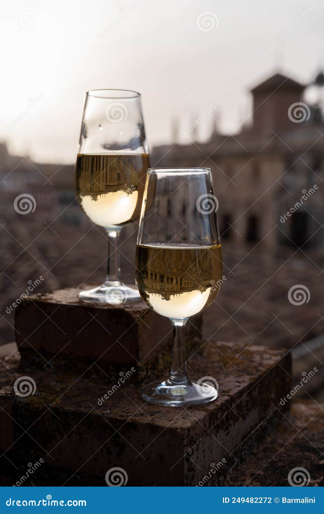 tasting of sweet and dry fortified vino de jerez sherry wine with view on roofs and houses of old andalusian town