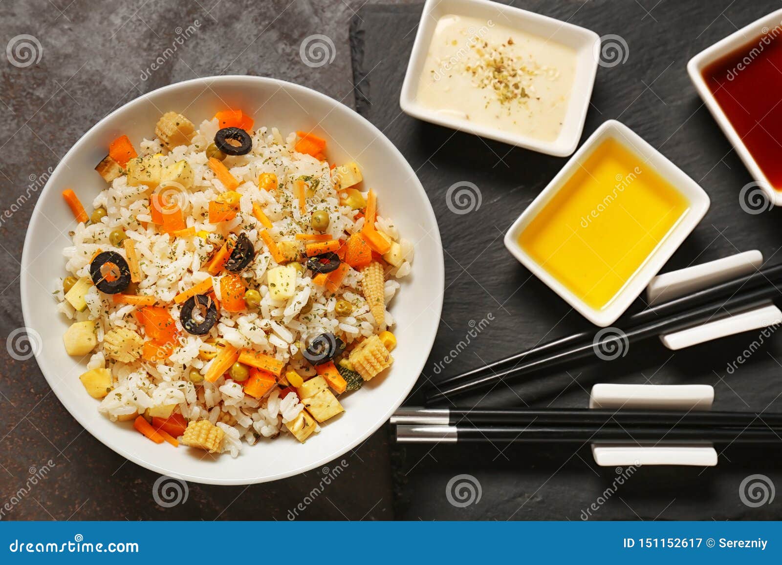 Tasty Boiled Rice with Vegetables and Different Sauces on Table Stock
