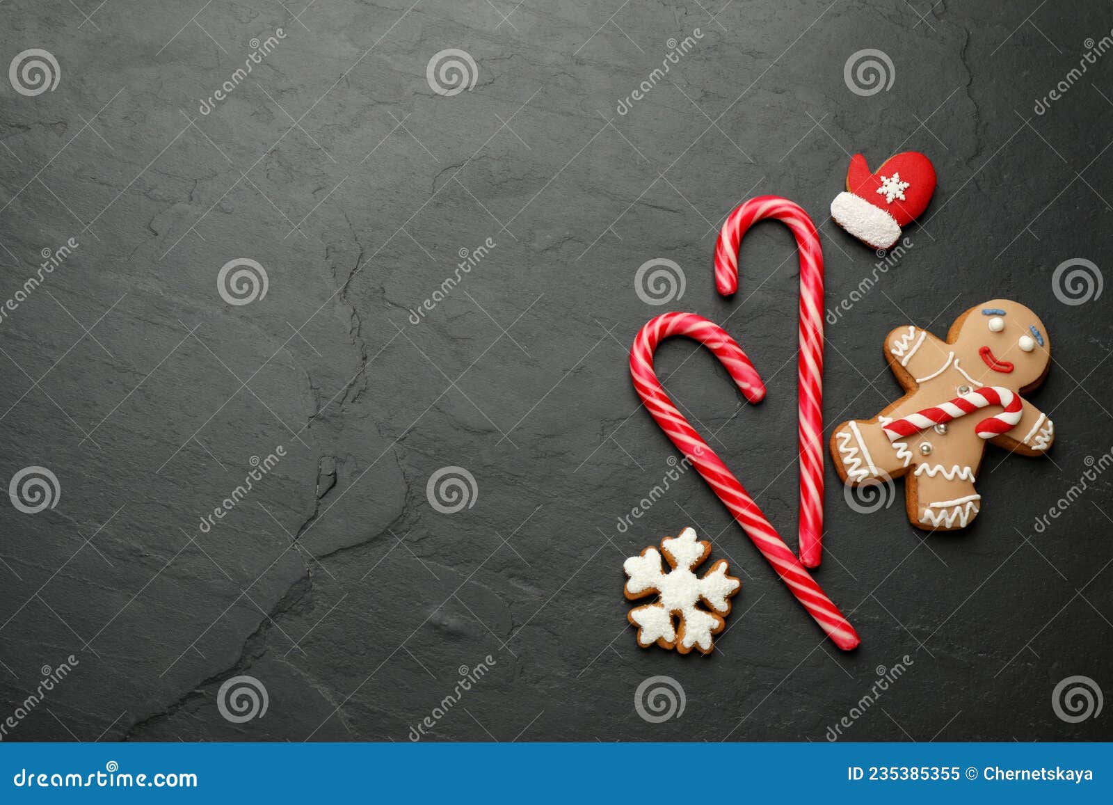 Tasty Candy Canes and Gingerbread Cookies on Black Table, Flat Lay