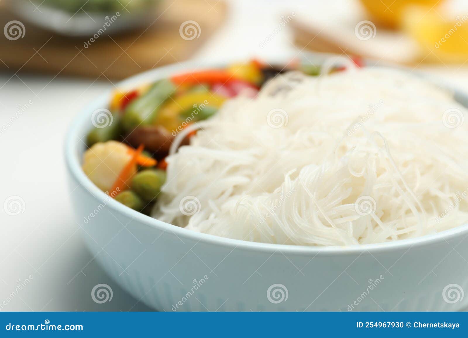 Tasty Cooked Rice Noodles with Vegetables on Table, Closeup Stock Photo