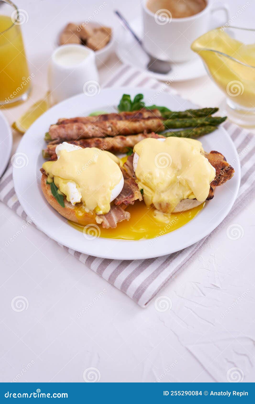 Tasty Eggs Benedict, Hollandaise Sauce and Aspargus Covered with Bacon