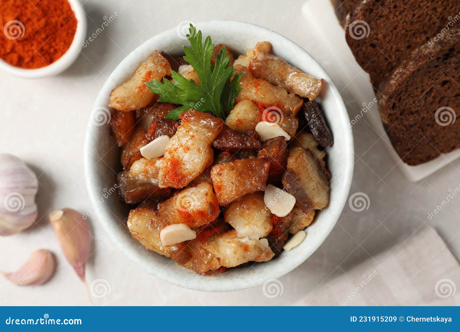 Tasty Fried Cracklings on Light Table, Flat Lay. Cooked Pork Lard Stock