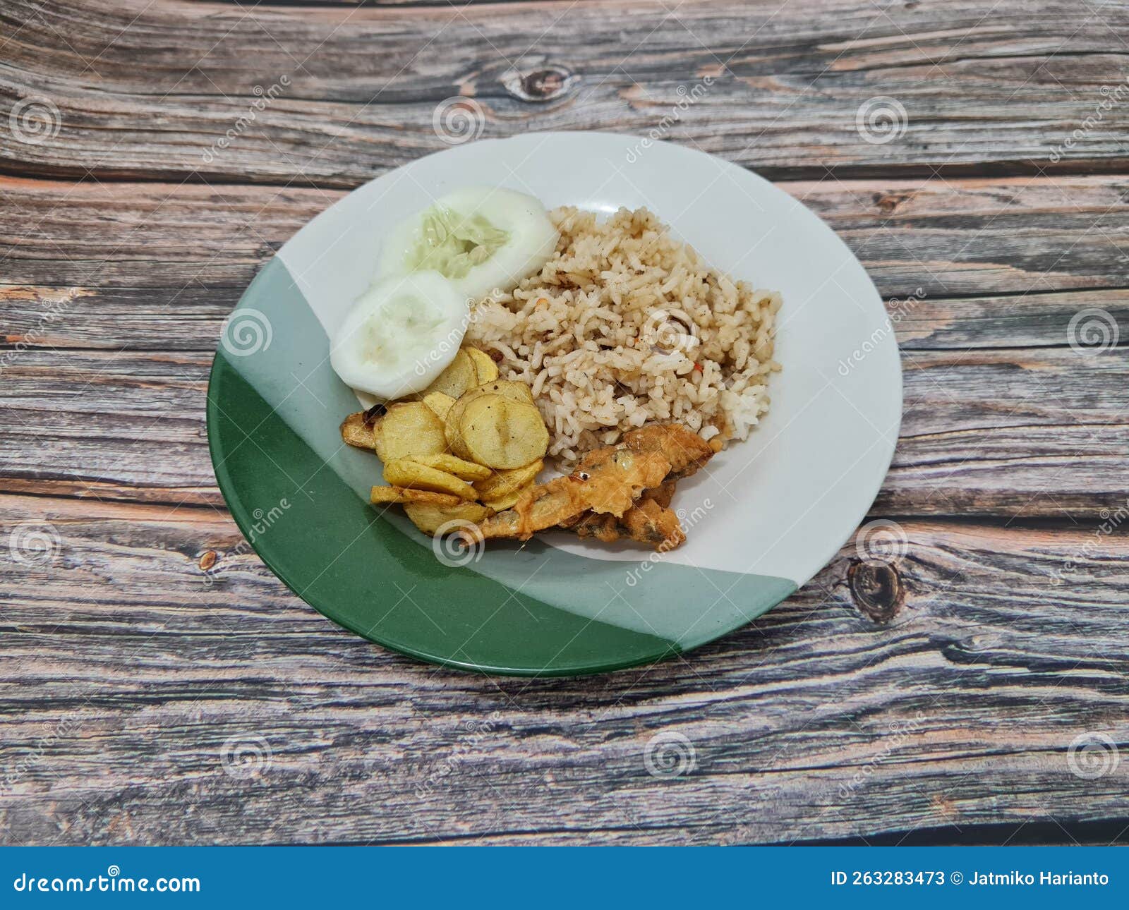 Tasty Fried Rice in a Plate with a Side Dish of Fried Fish Plus