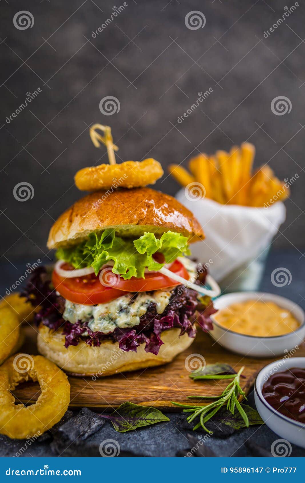 tasty grilled beef burger with spinach lettuce and blue cheese s