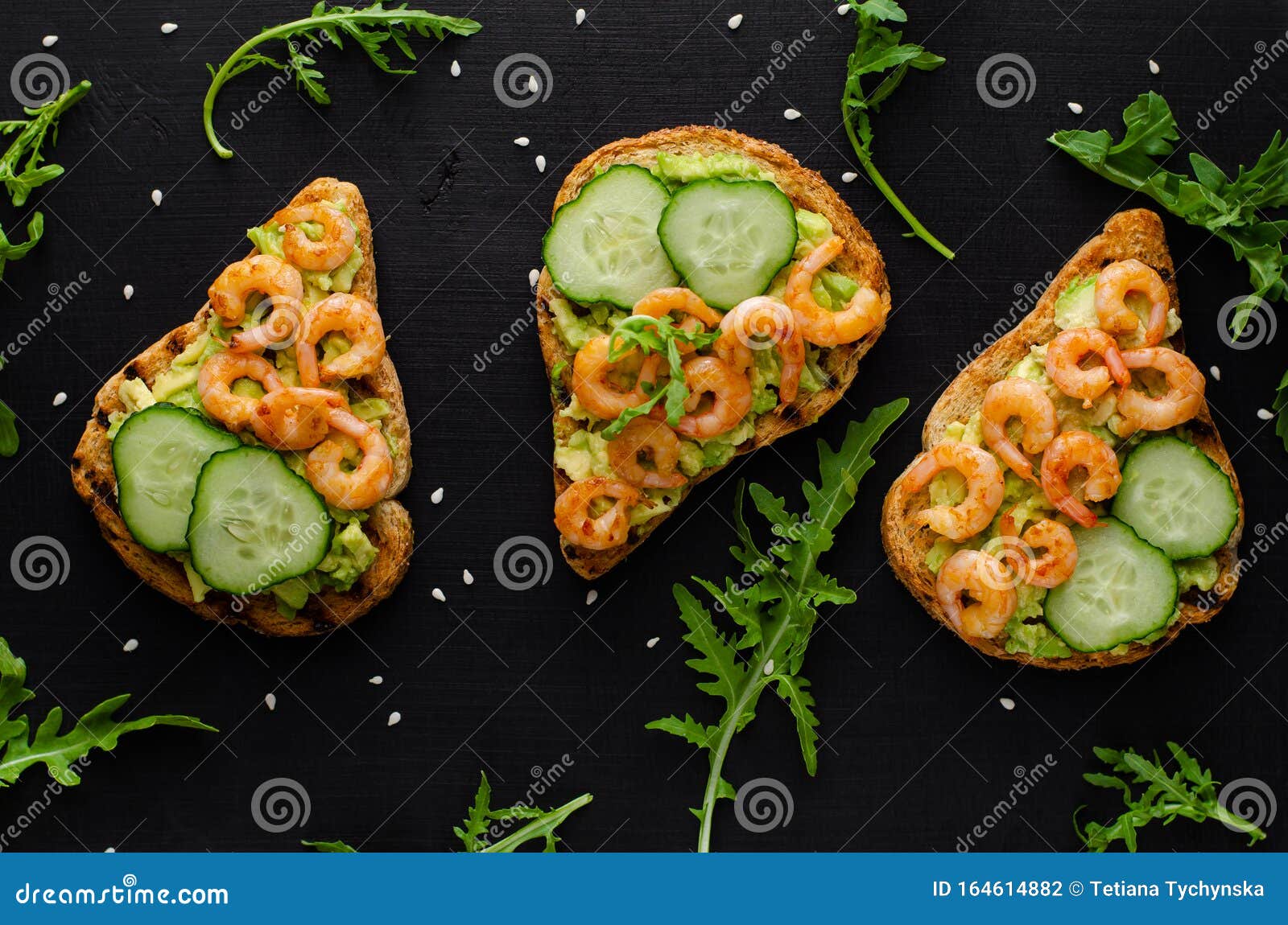 Tasty Healthy Snack with Avocado Toasts, Cucumber and Shrimps on Black ...