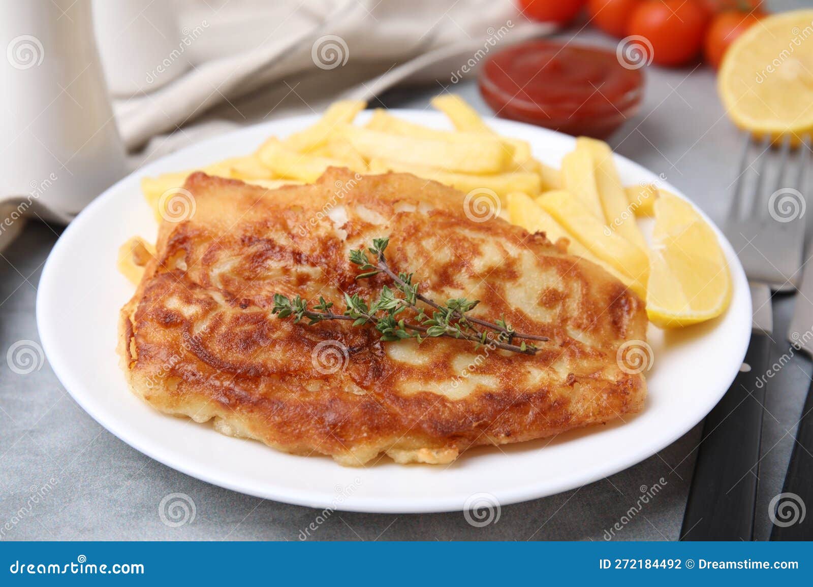 Tasty Soda Water Battered Fish, Potato Chips and Lemon Slice on Light