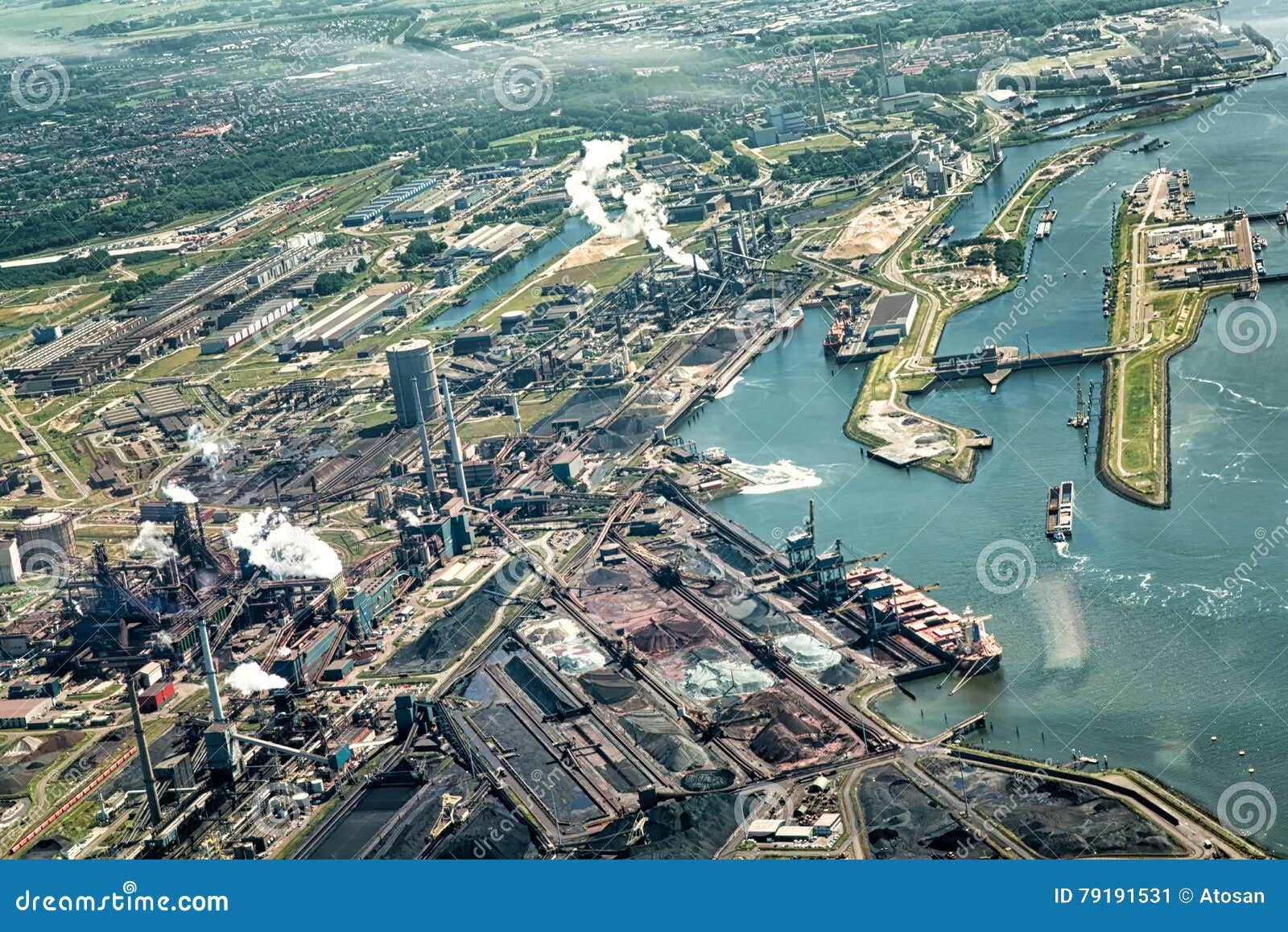 Factory Tata Steel with smoking chimneys on a sunny day, IJmuiden, The  Netherlands Stock Photo