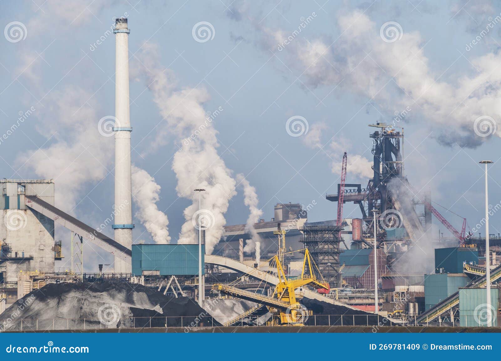 Factory Tata Steel with smoking chimneys on a sunny day, IJmuiden, The  Netherlands Stock Photo