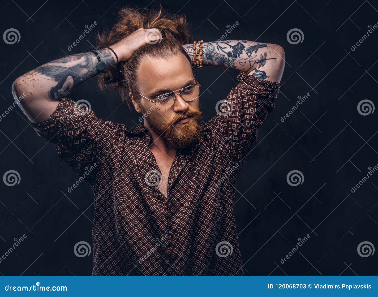Tattoed Redhead Man Hipster Corrects His Lush Hair Dressed