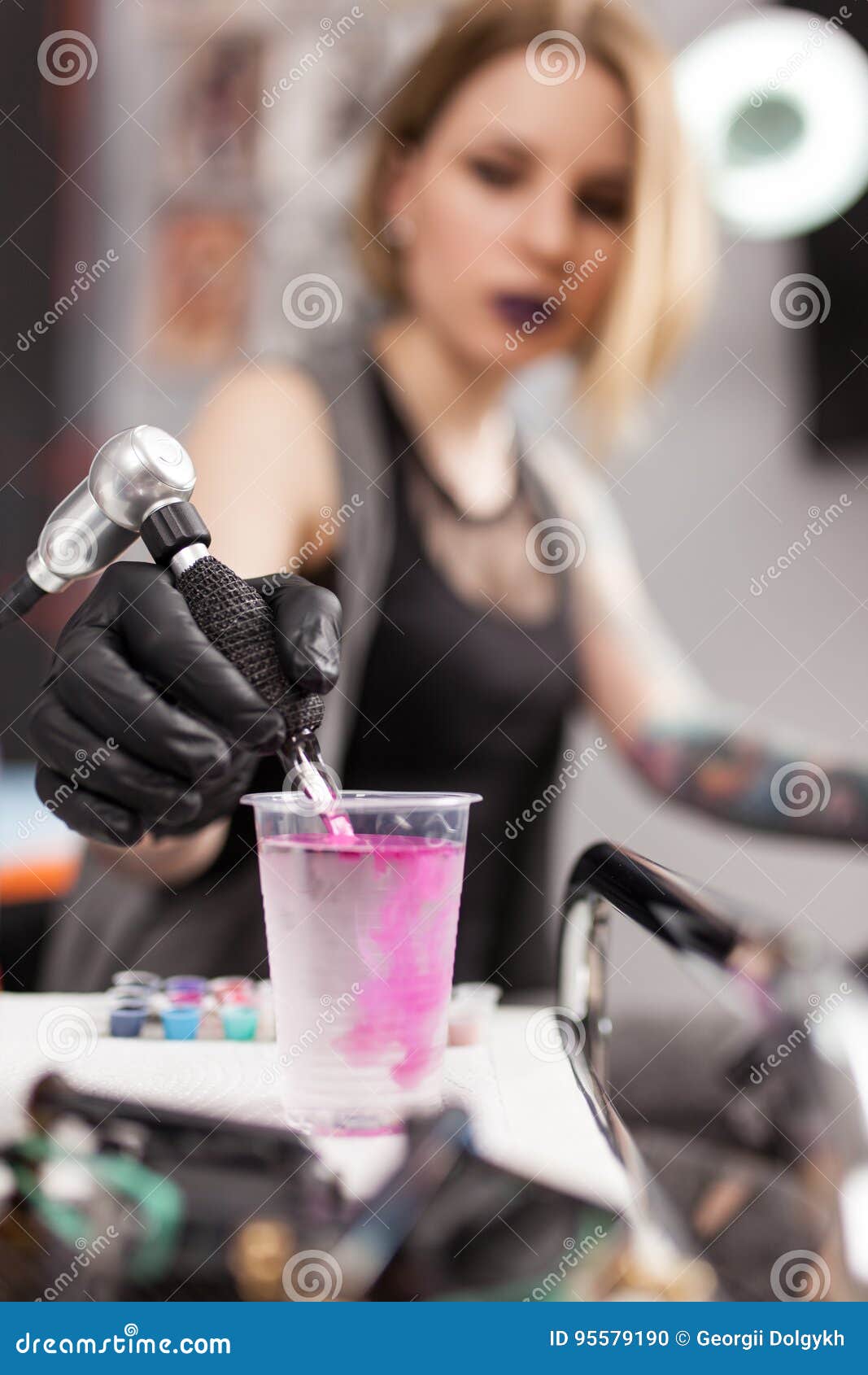 Tattoo artist in a studio stock photo. Image of salon 95579190