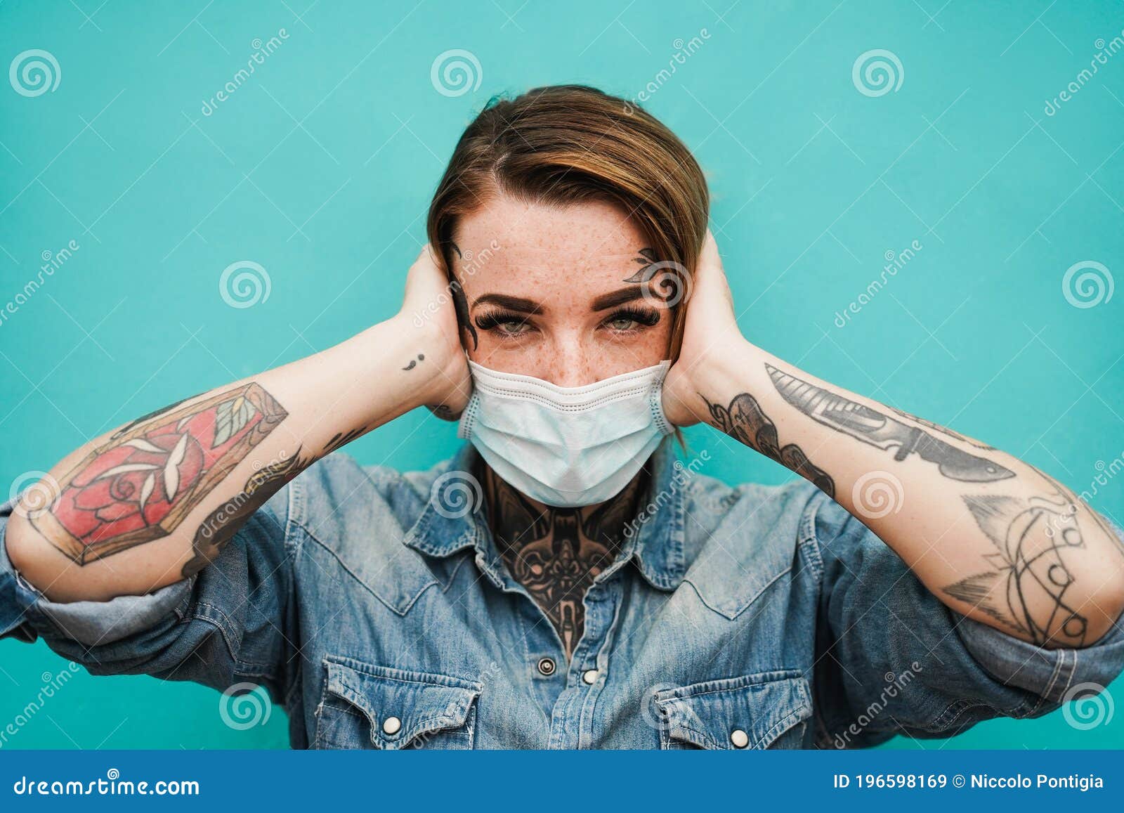 Tattoo girl wearing face protective mask during coronavirus outbreak - Follow safety measures
