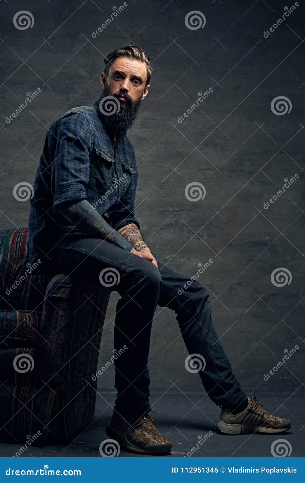 Tattooed Bearded Male Sits On A Chair. Stock Photo - Image of ...