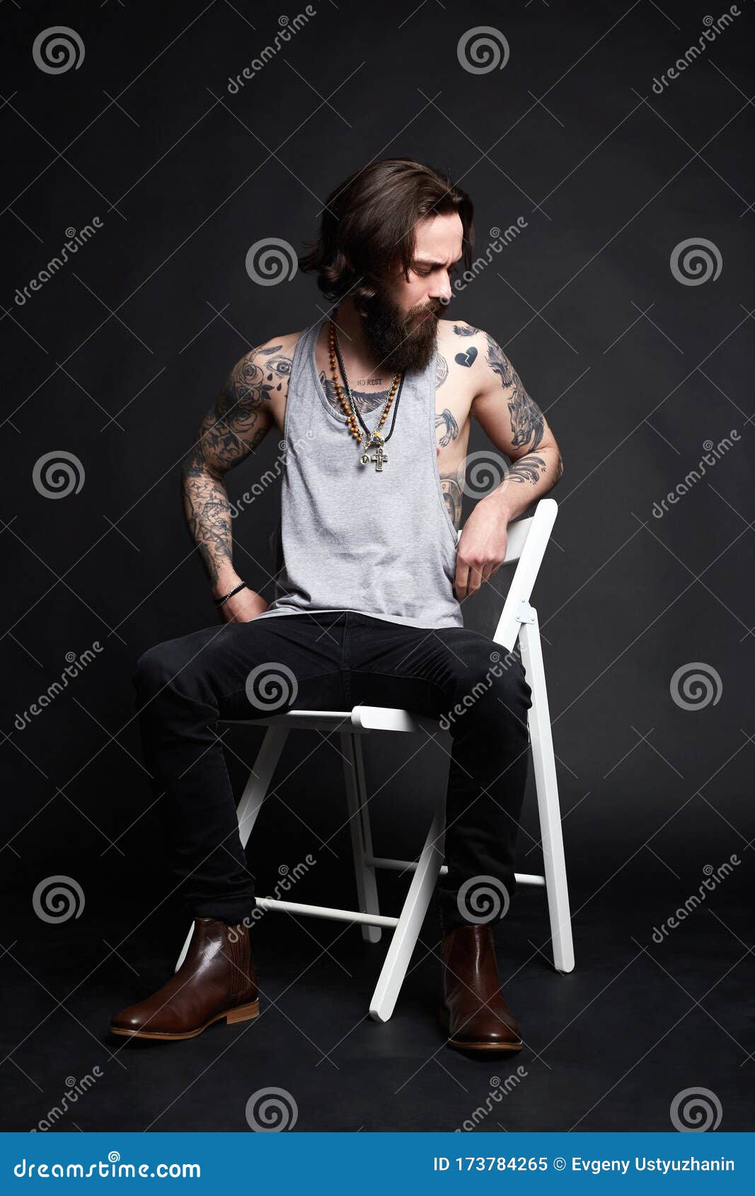 Tattooed Handsome Man Sitting on a Chair Stock Image - Image of dark ...