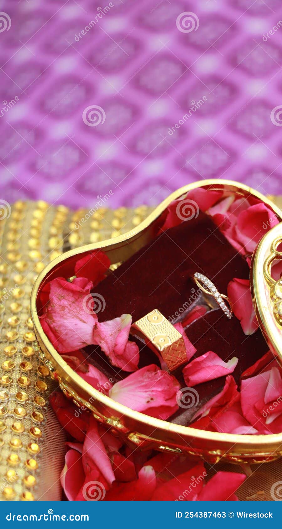 Tawny Heart-shaped Box with Wedding Rings and Rose Petals in it Stock ...