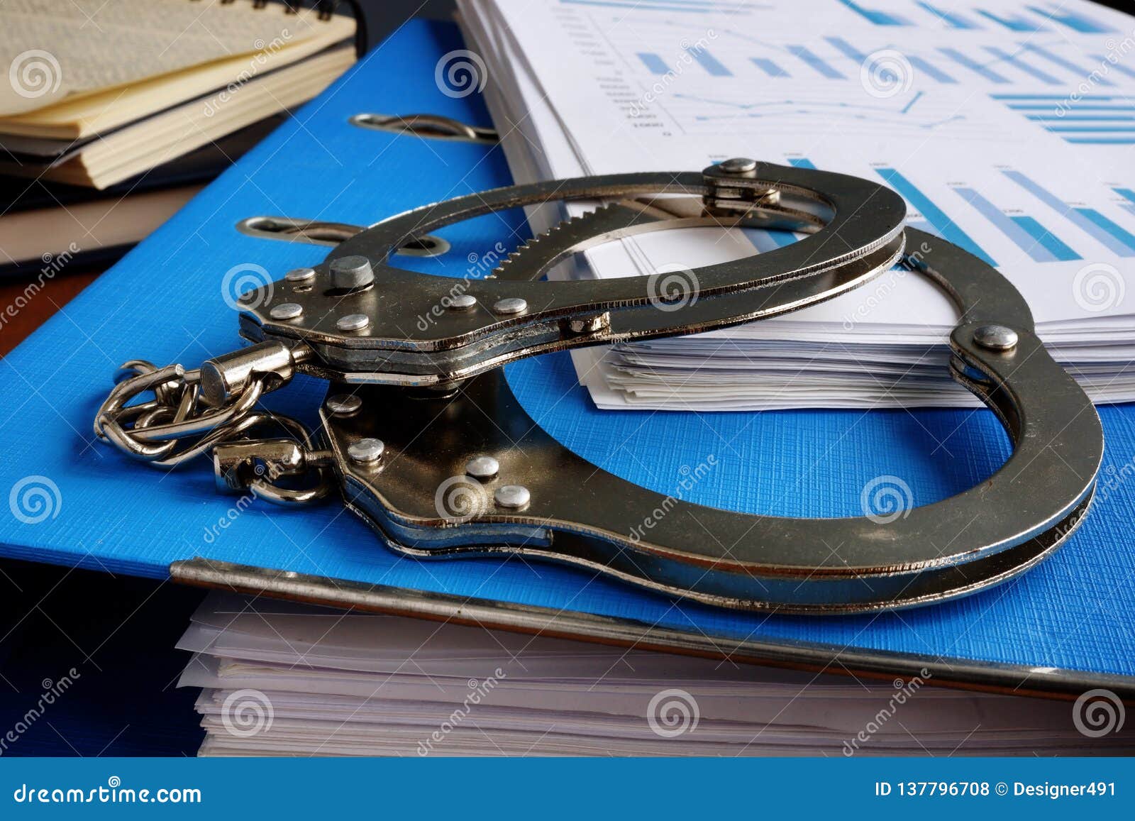 tax evasion. handcuffs and pile of financial papers