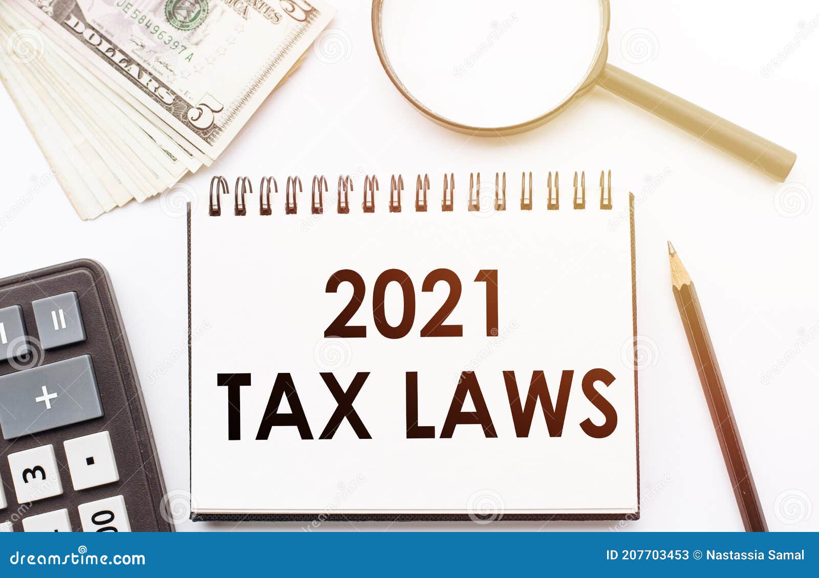 2021 TAX LAWS Text Written on a Notebook with Office Background Stock