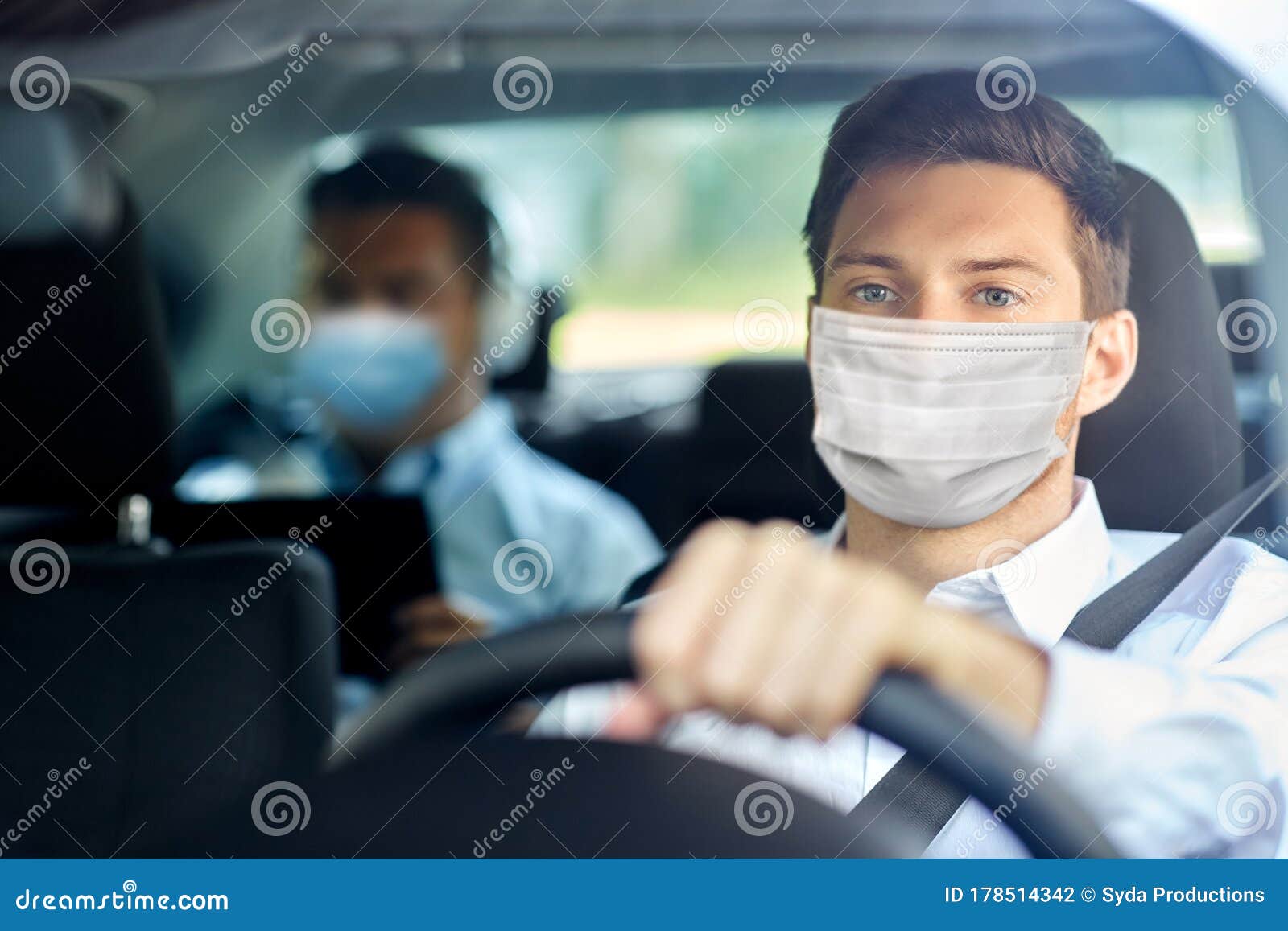 taxi driver in face protective mask driving car