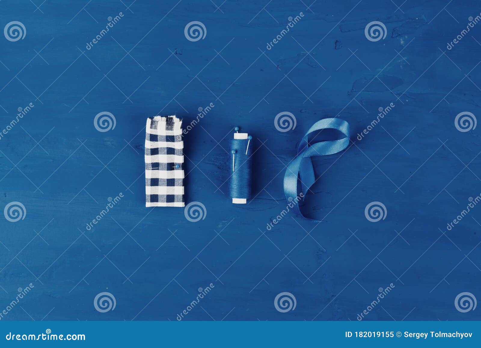 tayloring accessories on classic blue background, top view