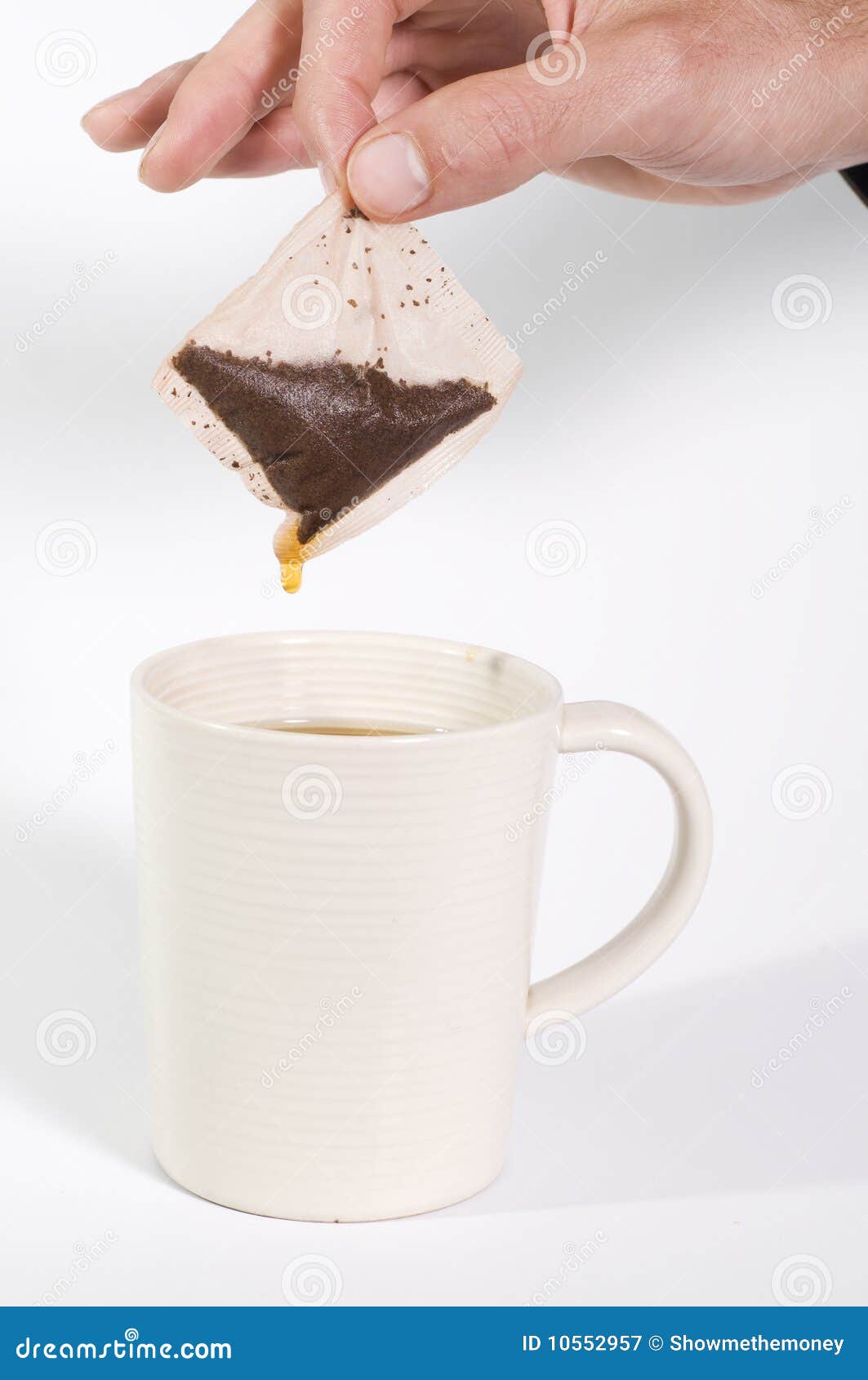 Tea bag and cup stock image. Image of hand, white, holding 10552957