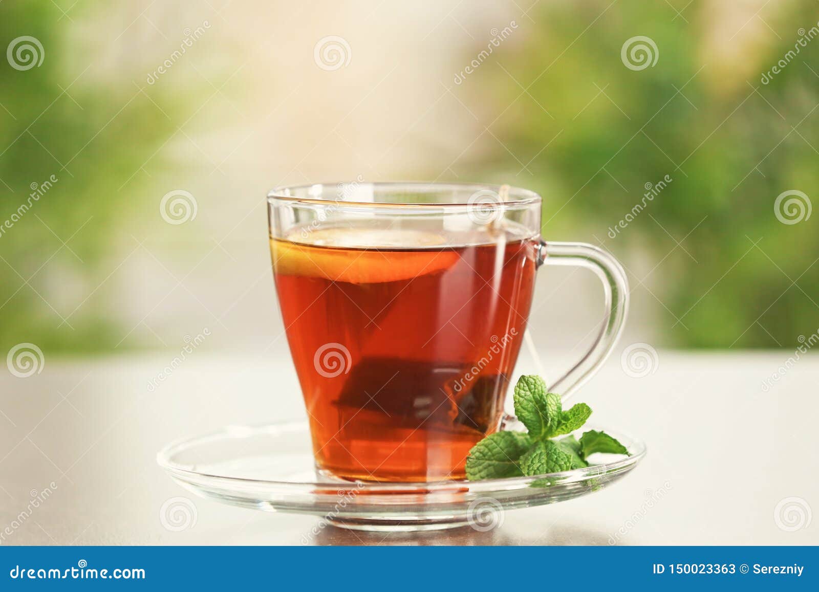 Tea Bag Dipped in Cup with Hot Beverage on Table Stock Image Image of