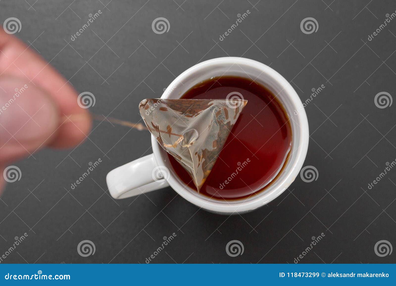 A tea bag in a white cup. stock image. Image of beverage 118473299