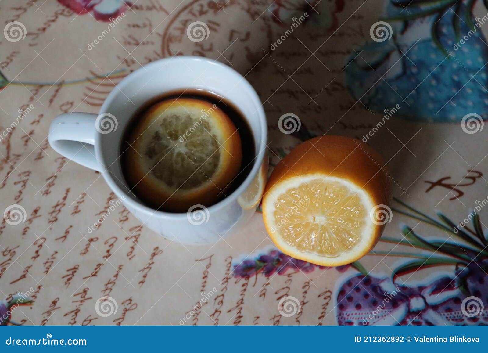 white cup of tea with citrus lemon on the table top view