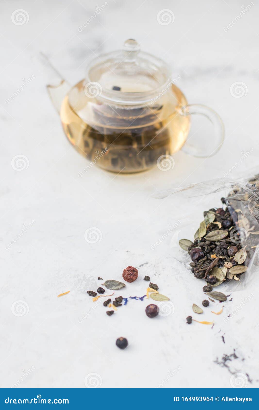 Tea in a Glass Teapot. Herbal Tea with Berries and Honey Stock Photo