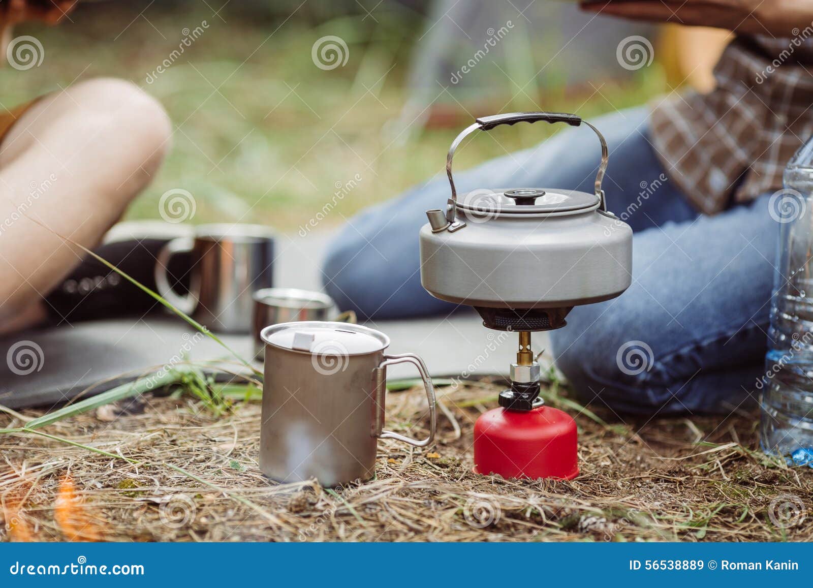 A Tea Kettle on a Propane Stove Next To a Metal Cup Stock Image Image