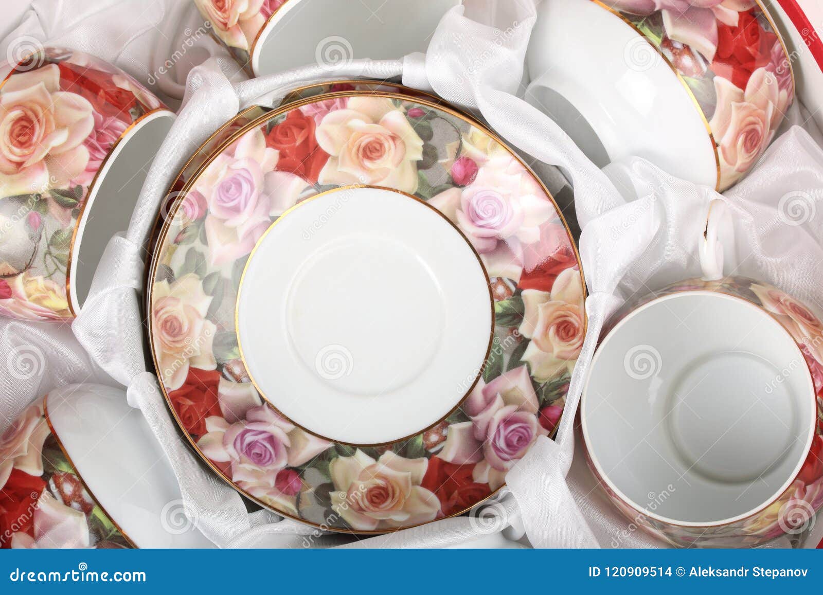 Tea Set with Floral Pattern in a Box with White Cloth. Top View Stock
