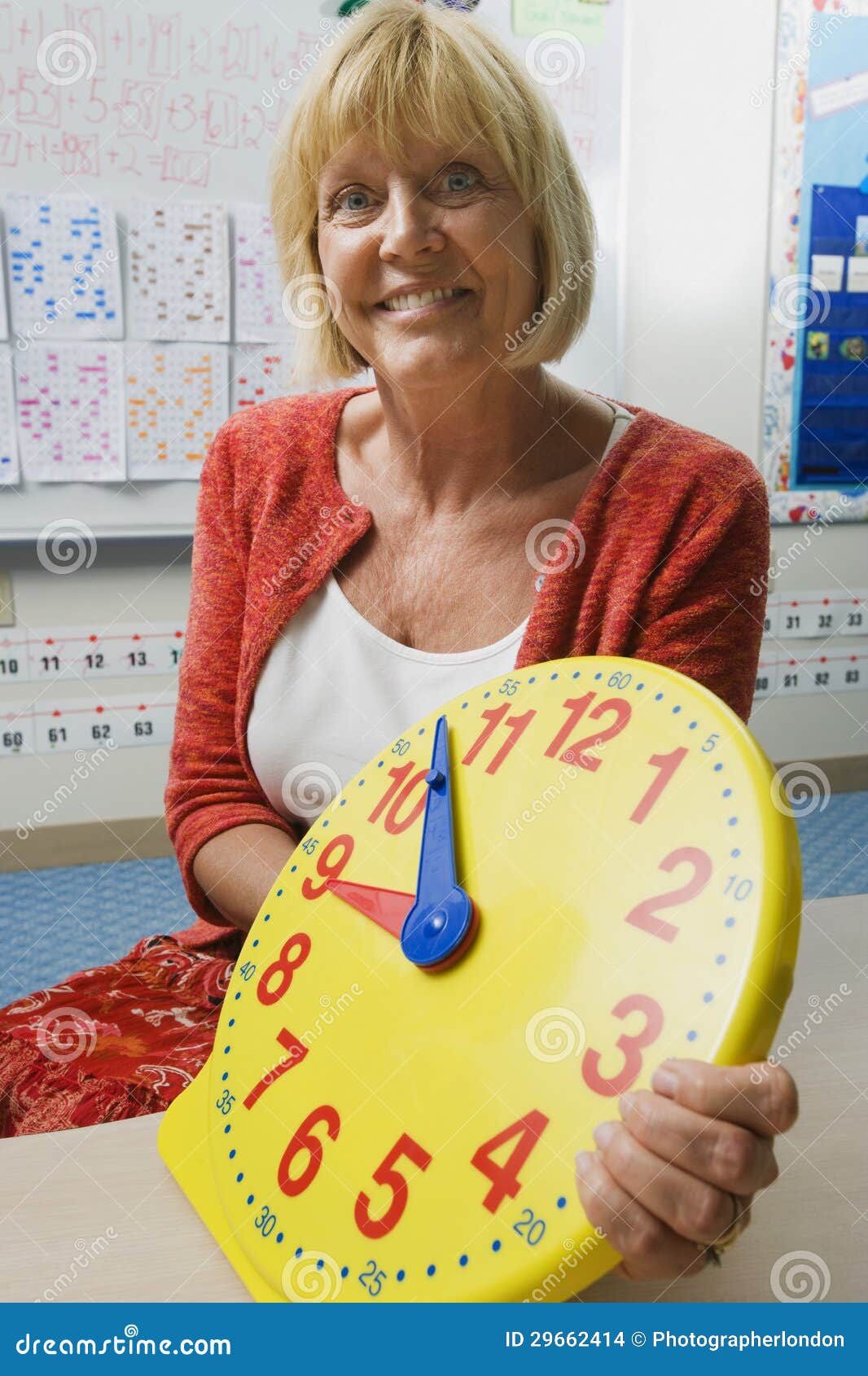 Teacher Holding a Time Teaching Clock Stock Photo Image of middle