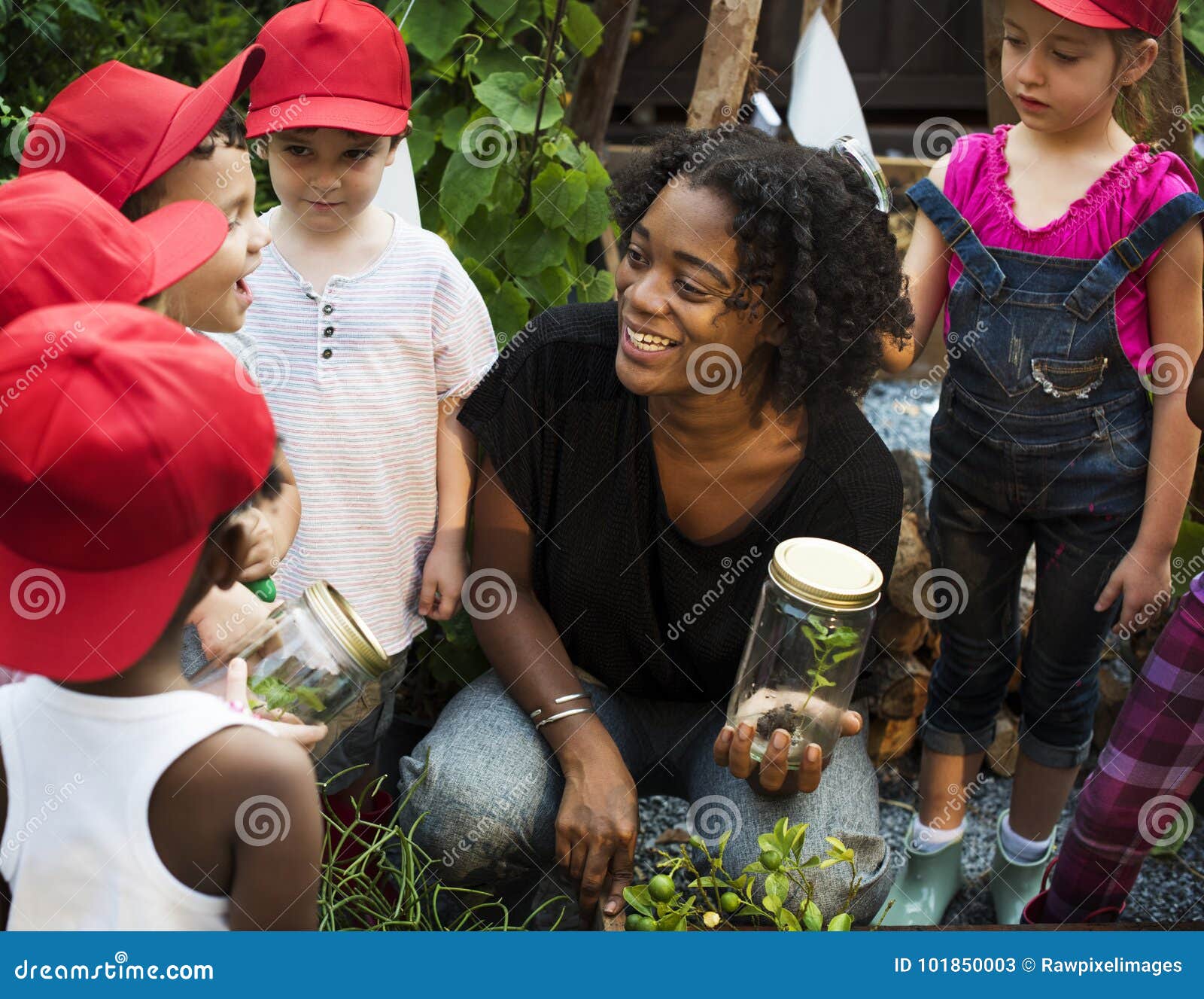 teacher and kids having fun learning about plants