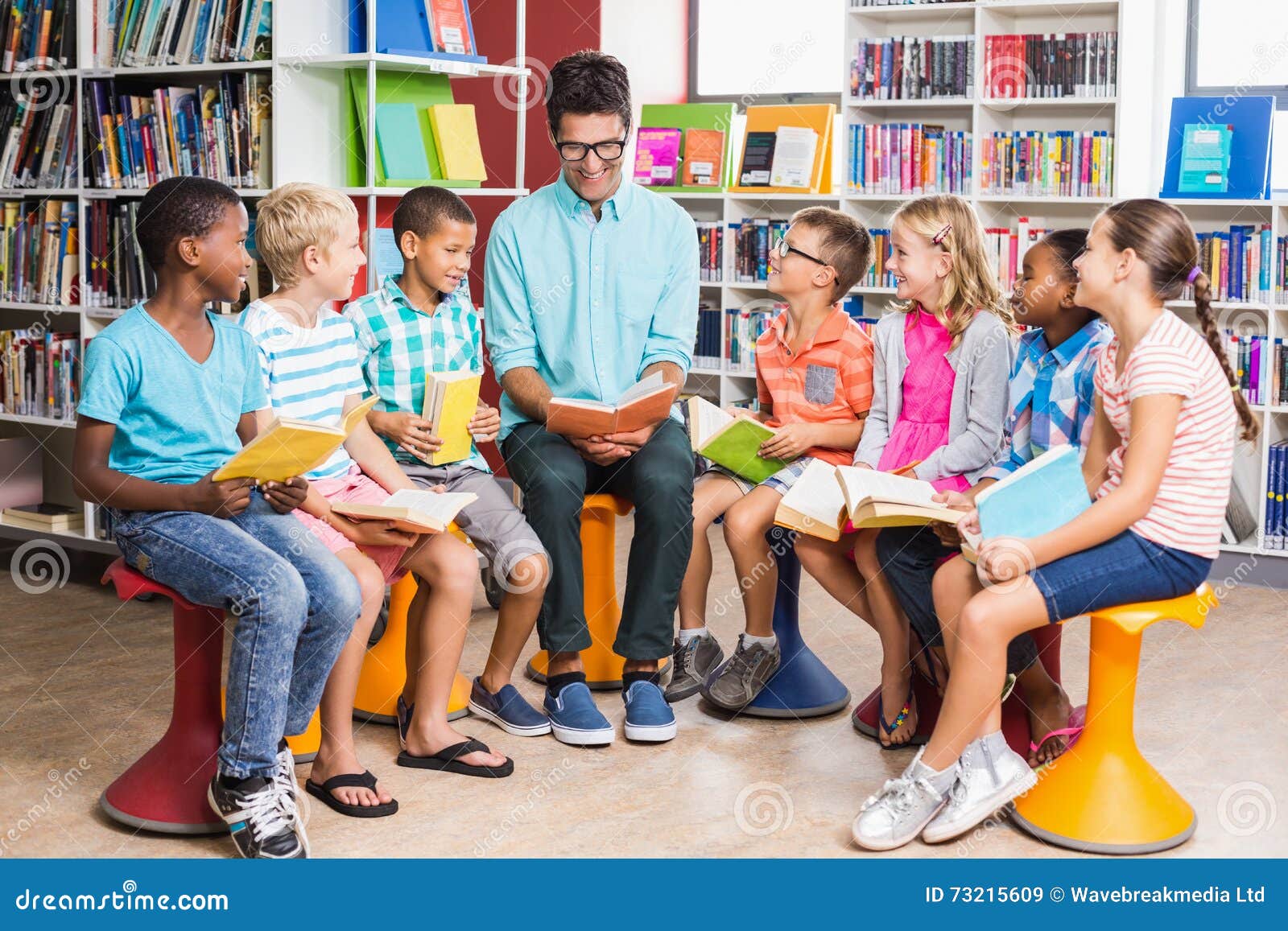 Teacher and Kids Reading Book in Library Stock Image Image of