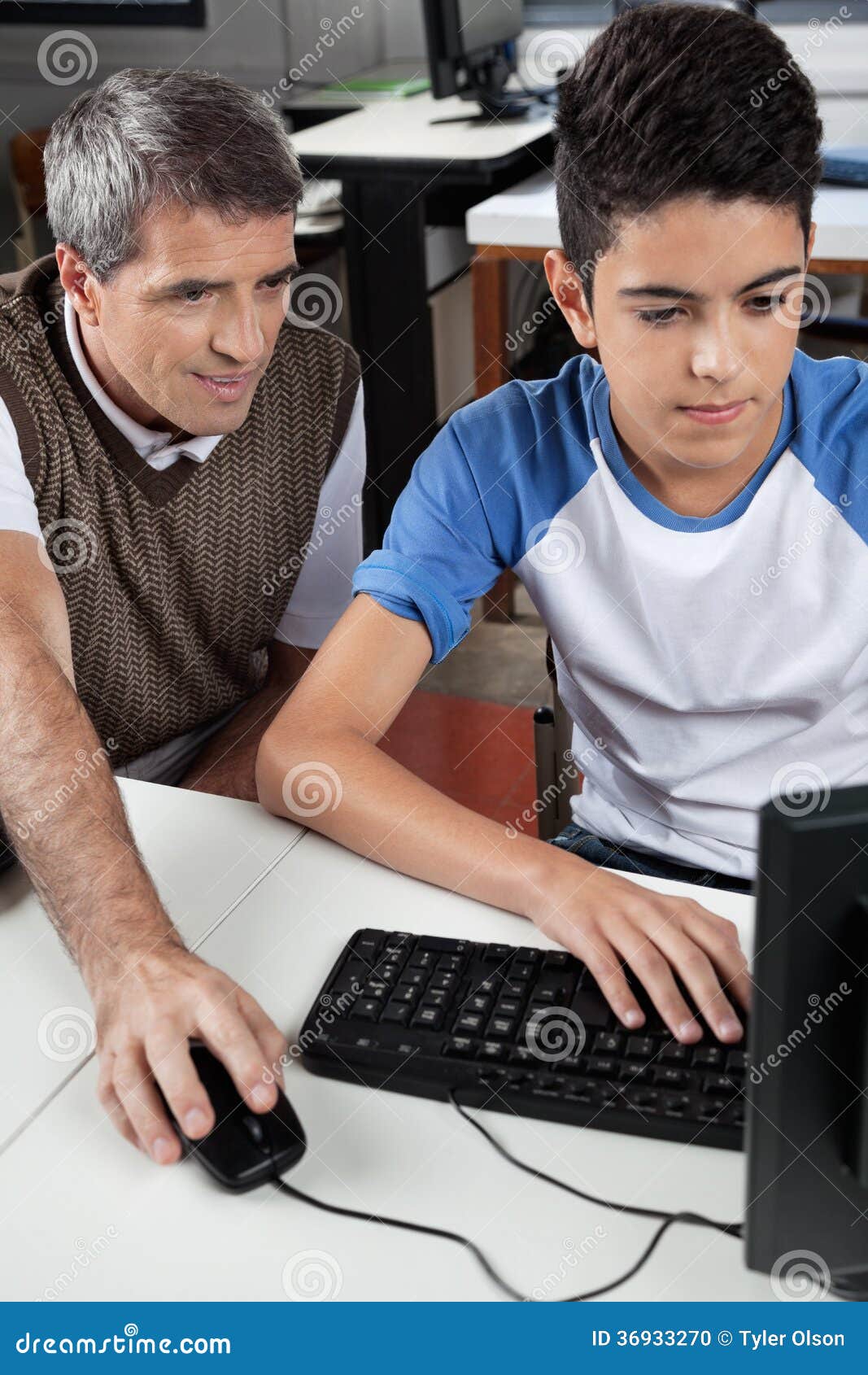 Teacher with Male Student Using Computer at Desk Stock Photo Image of