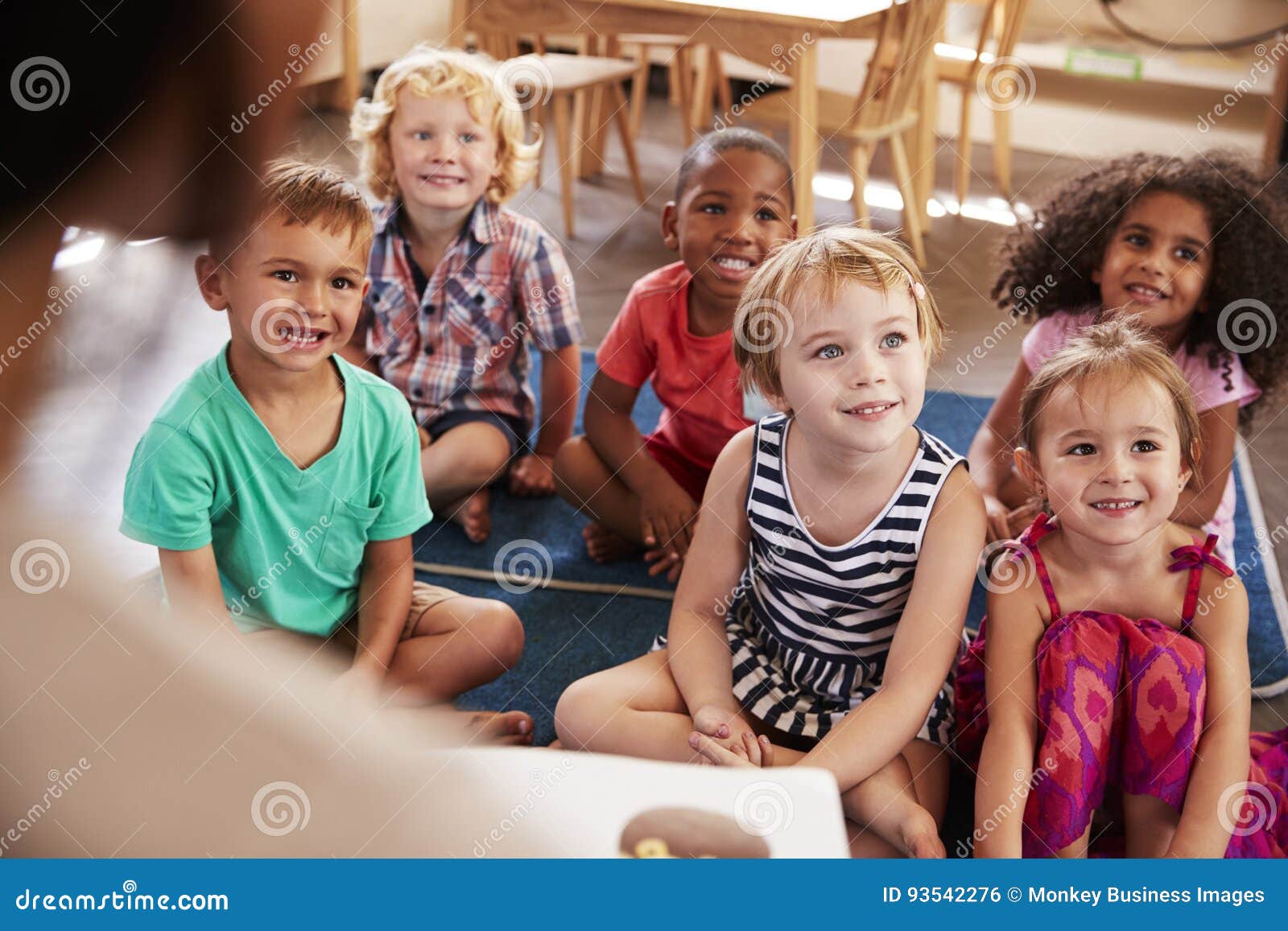 teacher at montessori school reading to children at story time